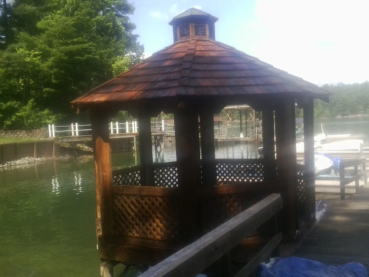 Cedar shake gazebo roof rebuilt on a lake dock in Lacrosse