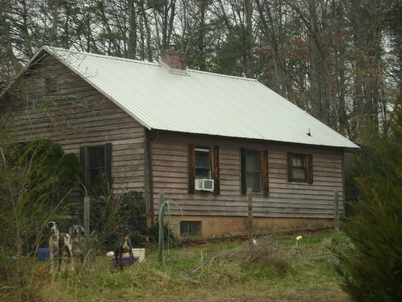 White metal roof on an old wood sided farmhouse, from a Metal Roof Installation job in Lacrosse